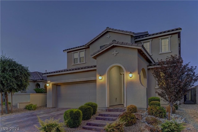 mediterranean / spanish-style home featuring a garage and solar panels