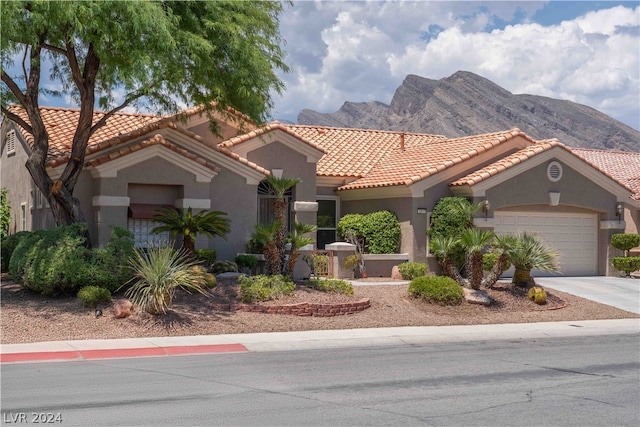 mediterranean / spanish house with a mountain view and a garage