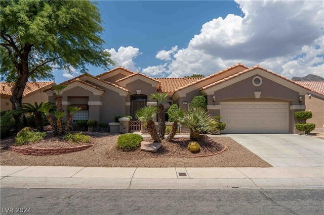 mediterranean / spanish-style home with a garage