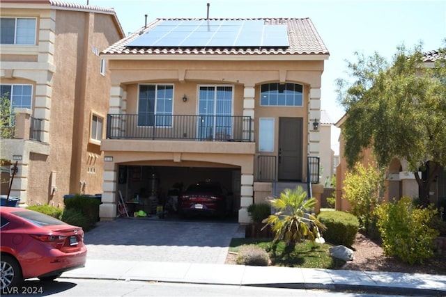 view of front facade featuring a garage and solar panels