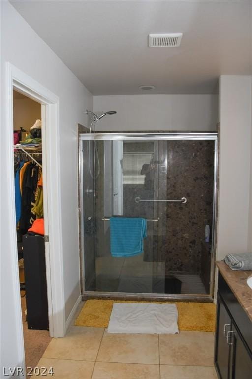 bathroom featuring an enclosed shower, vanity, and tile patterned floors