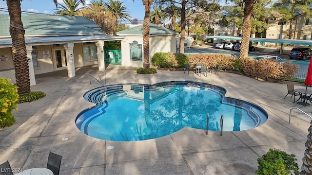 view of pool with french doors and a patio