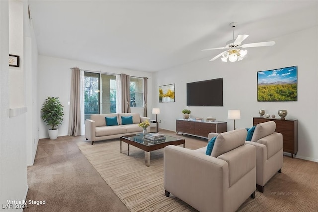 carpeted living room with ceiling fan