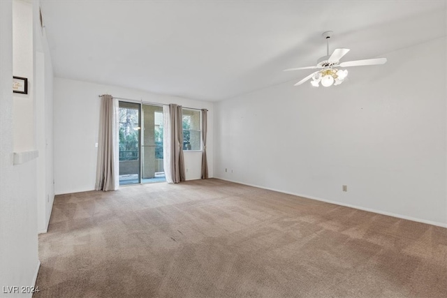 carpeted spare room with ceiling fan