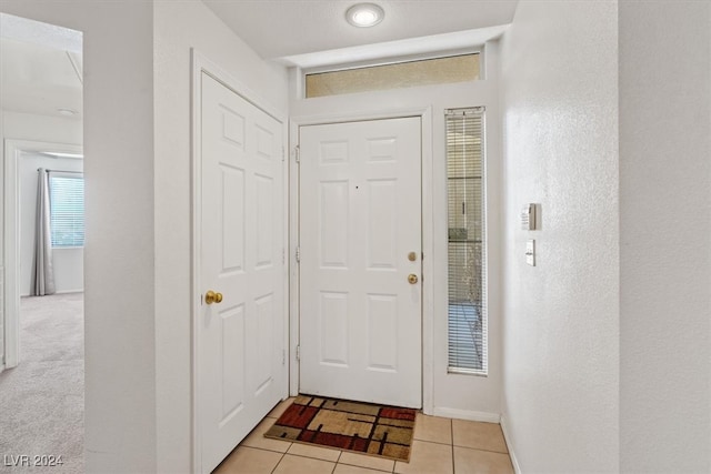 foyer entrance with light tile patterned floors