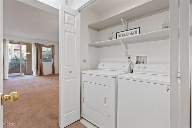 clothes washing area featuring washer and dryer and light carpet