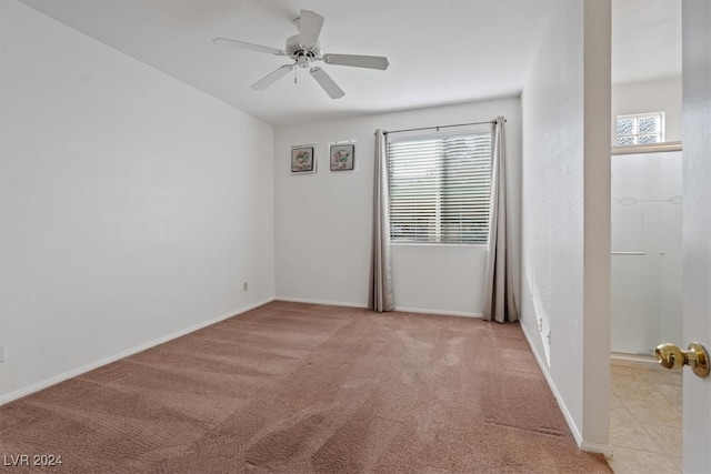 carpeted empty room featuring ceiling fan and plenty of natural light