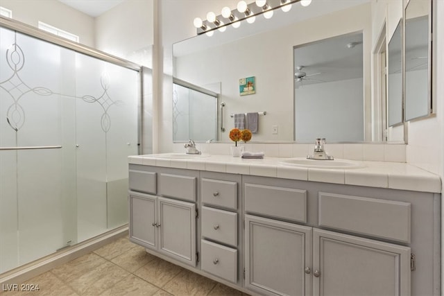 bathroom with vanity, ceiling fan, and a shower with shower door