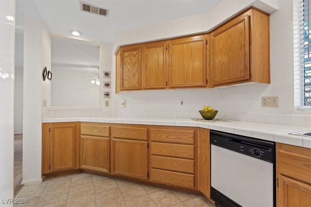 kitchen with dishwasher, tile countertops, ceiling fan, and light tile patterned flooring