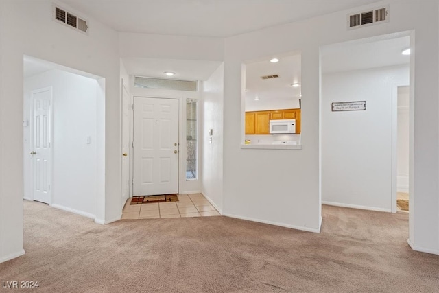 view of carpeted foyer