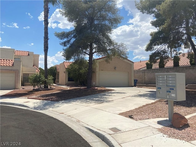 view of front of property featuring stucco siding, fence, driveway, and a tiled roof