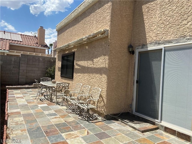 view of patio with outdoor dining area and fence