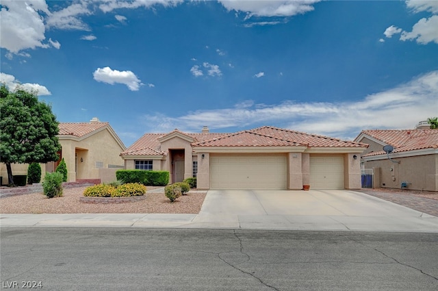 mediterranean / spanish-style home featuring a garage