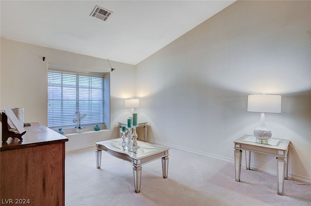 living room featuring carpet and vaulted ceiling