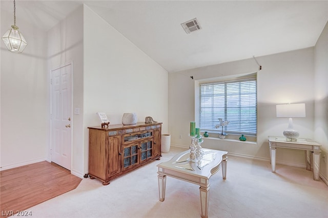 living room featuring carpet and vaulted ceiling