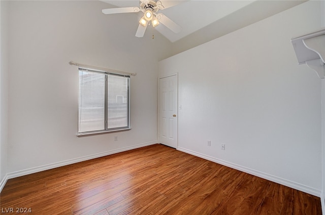 spare room featuring hardwood / wood-style floors, high vaulted ceiling, and ceiling fan