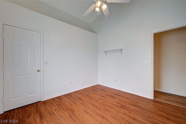 empty room with ceiling fan and hardwood / wood-style flooring