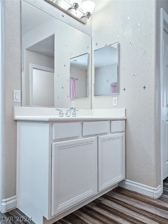 bathroom featuring vanity and wood-type flooring