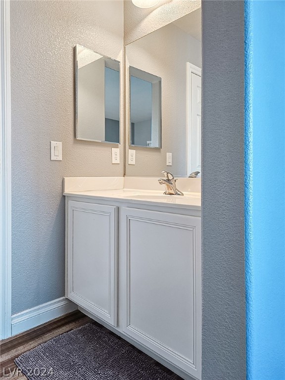 bathroom with vanity and hardwood / wood-style floors