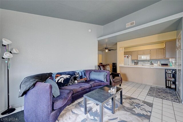 tiled living room featuring sink and ceiling fan