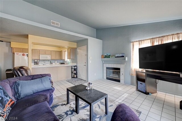 tiled living room with a tiled fireplace