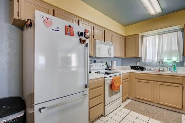 kitchen featuring tile counters, white appliances, sink, and light brown cabinets