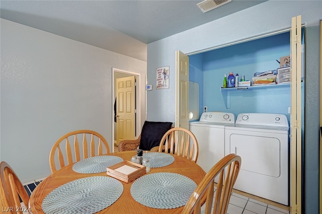 dining area with washer and clothes dryer and light tile patterned floors