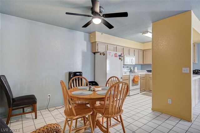 tiled dining room featuring ceiling fan