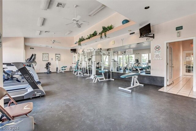 gym featuring ceiling fan and high vaulted ceiling