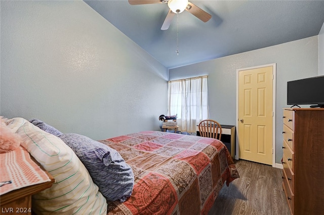 bedroom with lofted ceiling, dark hardwood / wood-style floors, and ceiling fan