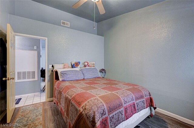 bedroom with ceiling fan and hardwood / wood-style flooring