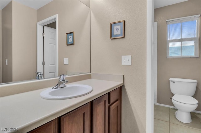 bathroom with tile patterned flooring, vanity, and toilet