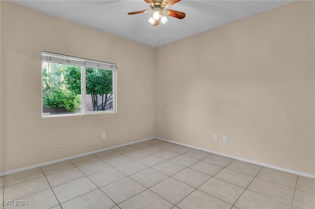 spare room featuring ceiling fan and light tile patterned flooring