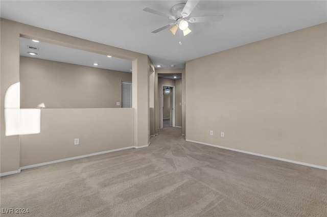 empty room with light colored carpet and ceiling fan