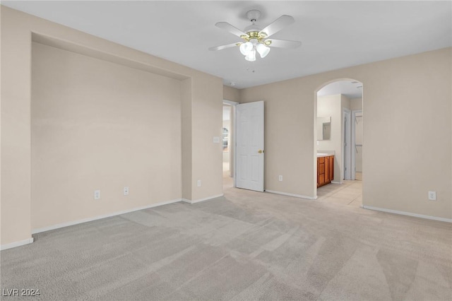 unfurnished room with ceiling fan and light colored carpet