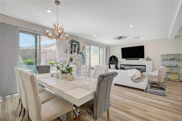 dining area with a notable chandelier and light wood-type flooring