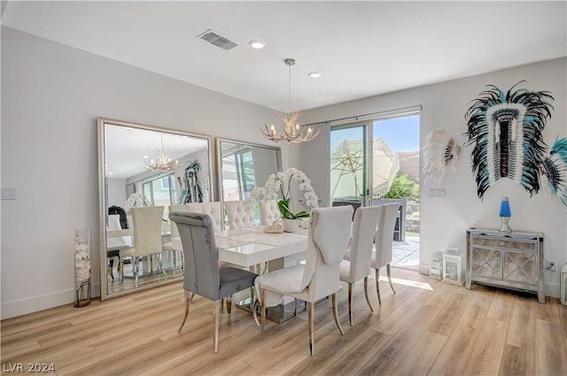 dining room with a chandelier and light hardwood / wood-style floors