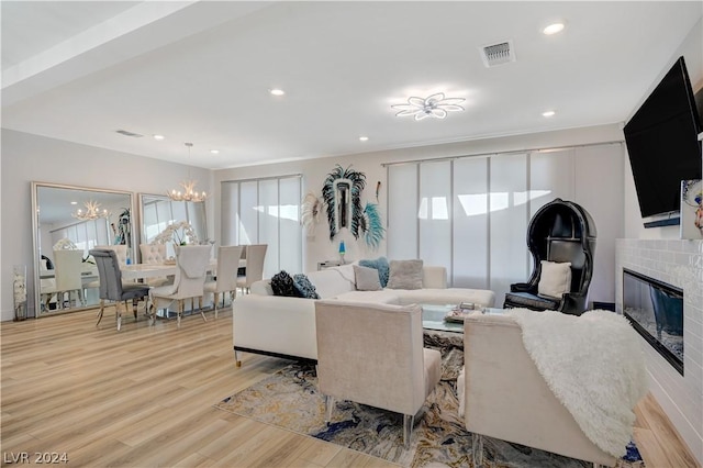 living room featuring light hardwood / wood-style flooring and a chandelier