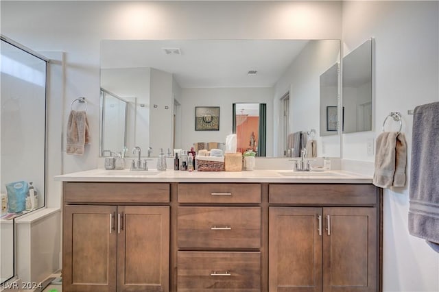 bathroom with a shower with door and vanity