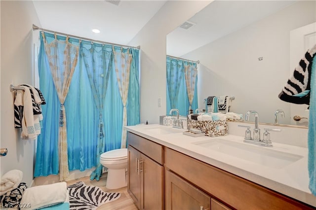 bathroom featuring vanity, hardwood / wood-style flooring, toilet, and a shower with shower curtain