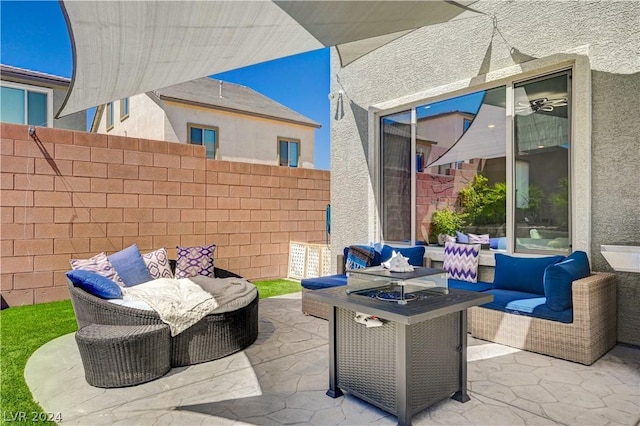 view of patio / terrace with an outdoor living space with a fire pit