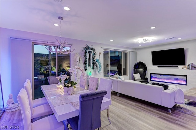 dining room featuring an inviting chandelier and light hardwood / wood-style flooring