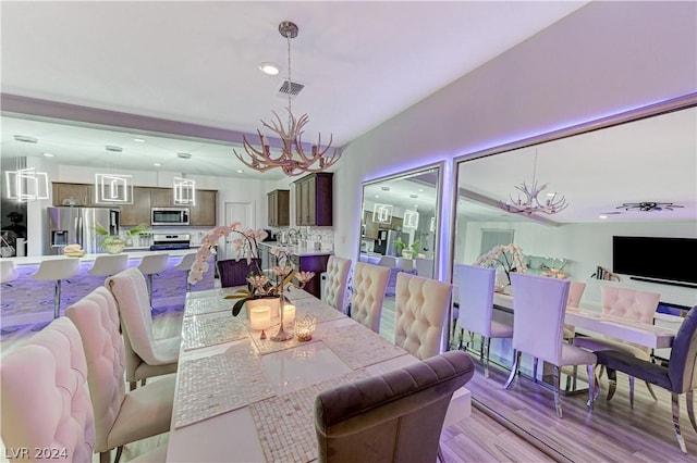 dining room featuring light hardwood / wood-style flooring and a chandelier