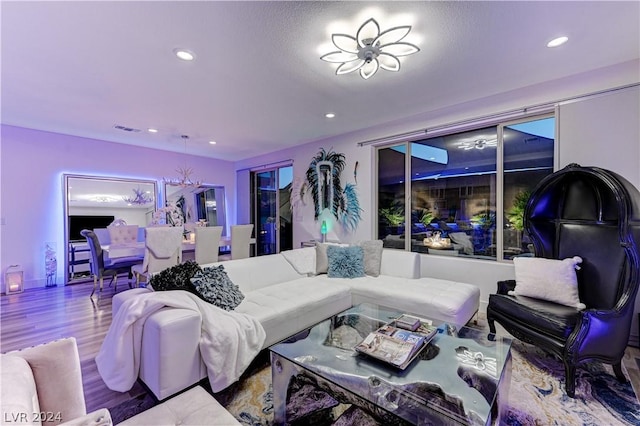 living room featuring hardwood / wood-style floors and a notable chandelier