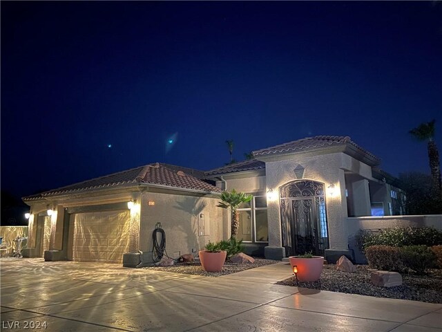 mediterranean / spanish home featuring a garage