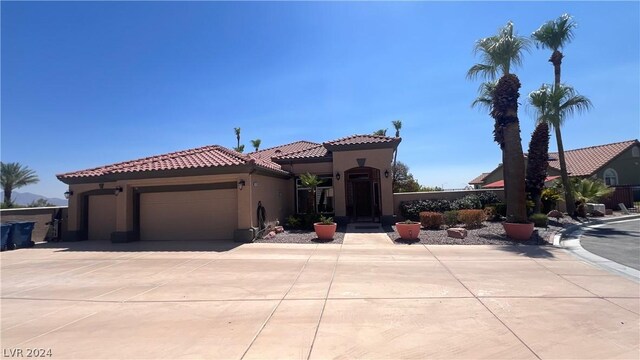 mediterranean / spanish house with a garage