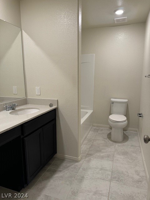 full bathroom with vanity, tub / shower combination, toilet, and tile patterned floors