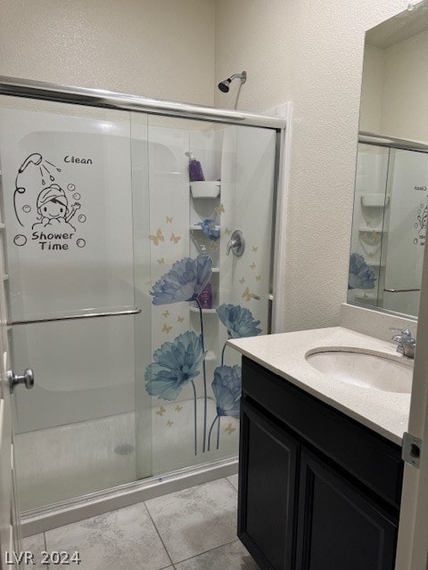 bathroom with tile patterned flooring, vanity, and an enclosed shower