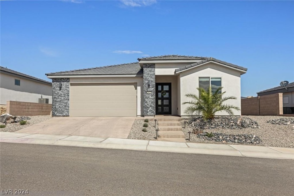 prairie-style home featuring a garage