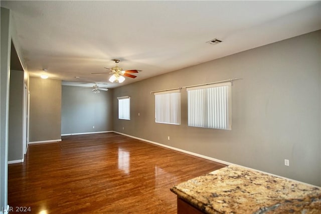 empty room with wood-type flooring and ceiling fan